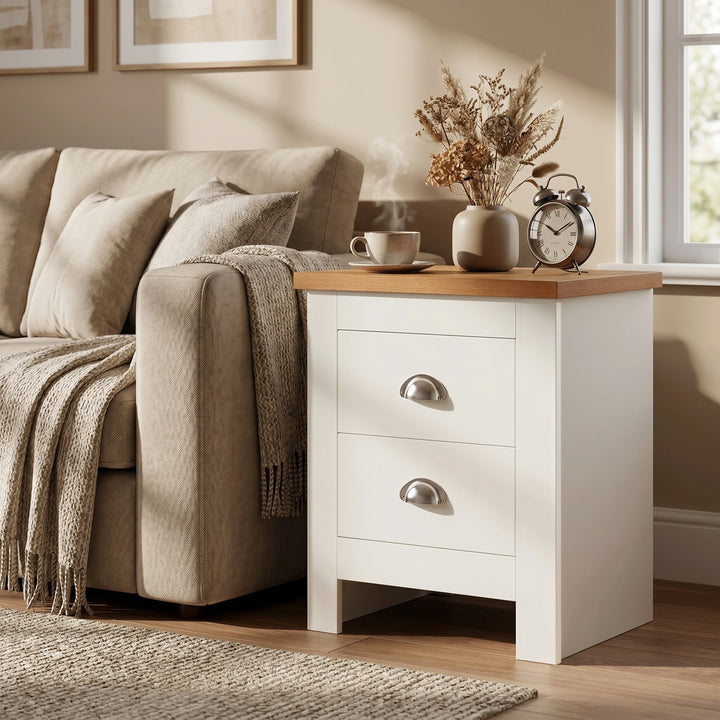 [White]  nightstand with wooden top next to a beige sofa in a cozy living room.