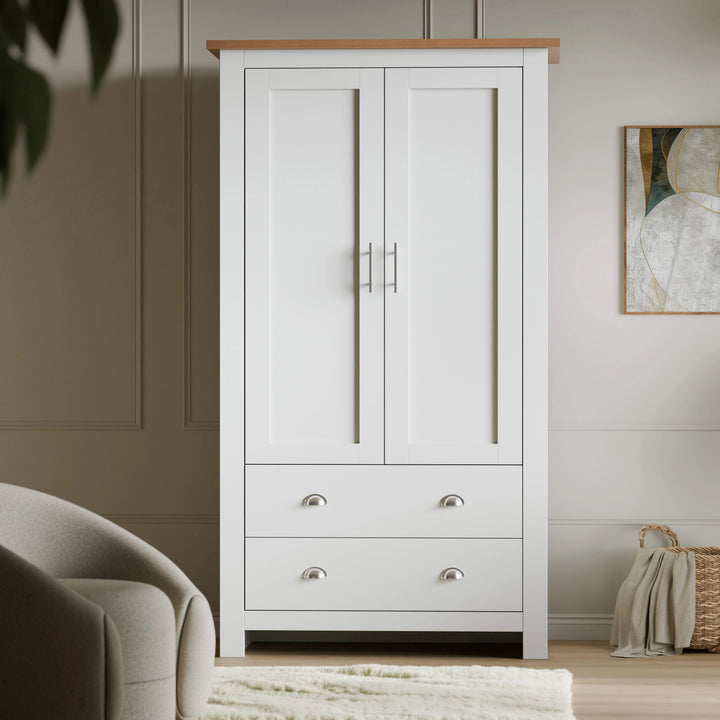 [White] Head-on white Shaker double wardrobe, oak top, two doors closed and two drawers, art to side
