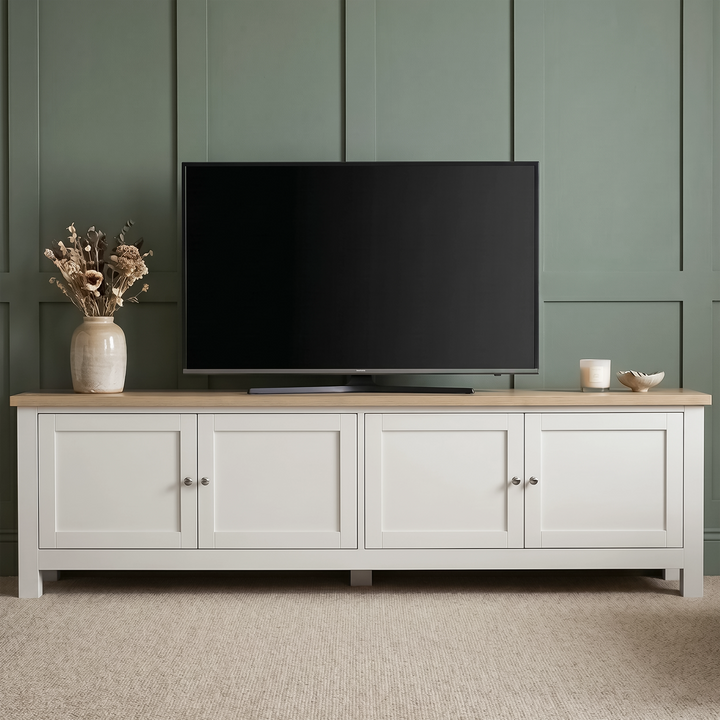 [White] Shaker TV unit 180cm lifestyle hero shot with large TV on top, green accent wall background