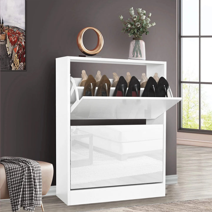 [White] white gloss 2 door shoe cabinet with top tilt-out open showing a row of heels and trainers in a hallway