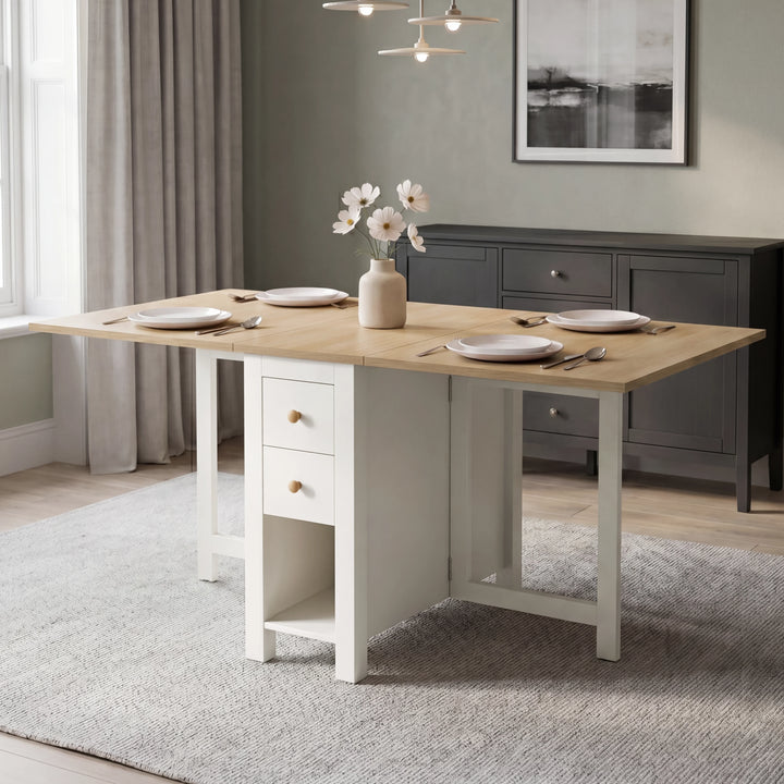 [130cm | White]  Stovra Drop Leaf Dining Table fully extended with four place settings in a green dining room