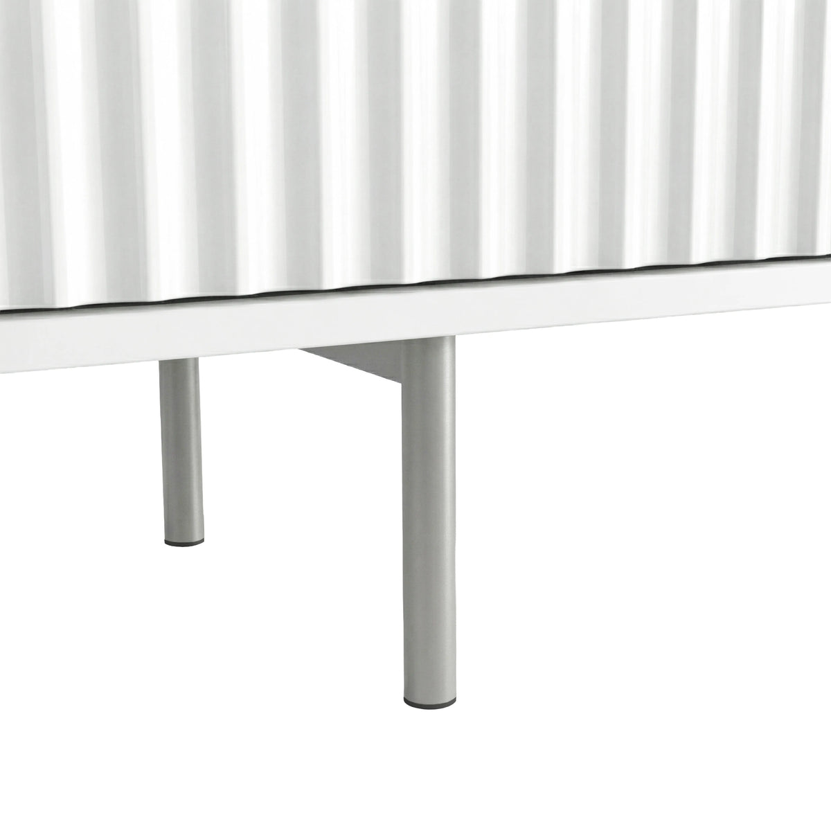 [White] Chrome leg hardware shot on white Flutrina TV unit, fluted door bottom edge visible above leg.
