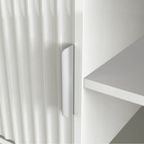 [White] Handle detail on white Flutrina TV unit door, vertical fluted grooves clearly visible across the door surface.