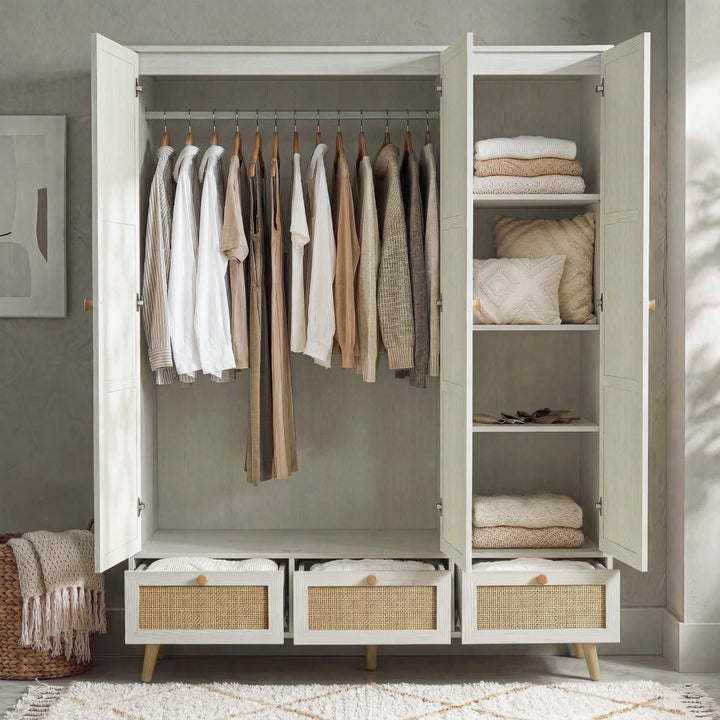 [White] Interior of Wovena 3 door wardrobe showing full-width rail with shirts and folded knitwear on side shelves