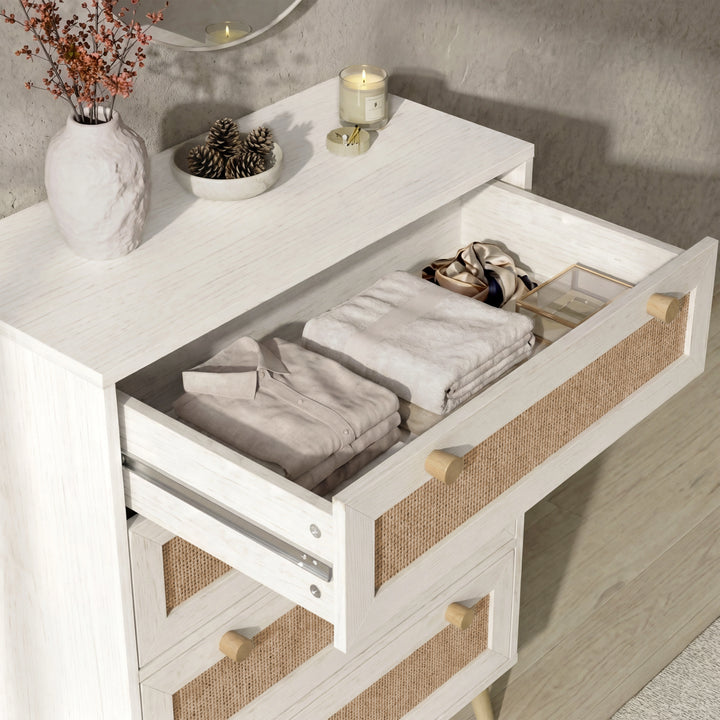 [White] Top drawer detail on Wovena rattan bedroom furniture set 4-drawer chest with neatly folded clothing inside