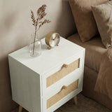 [White] Wovena bedside table side angle next to sofa showing rattan drawer fronts