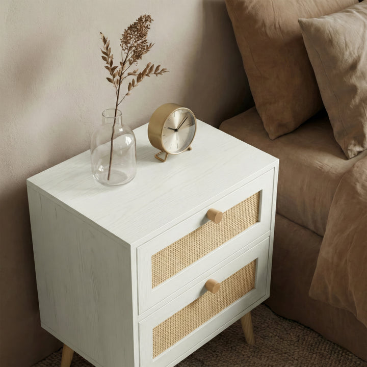 [White] Wovena bedside table side angle next to sofa showing rattan drawer fronts
