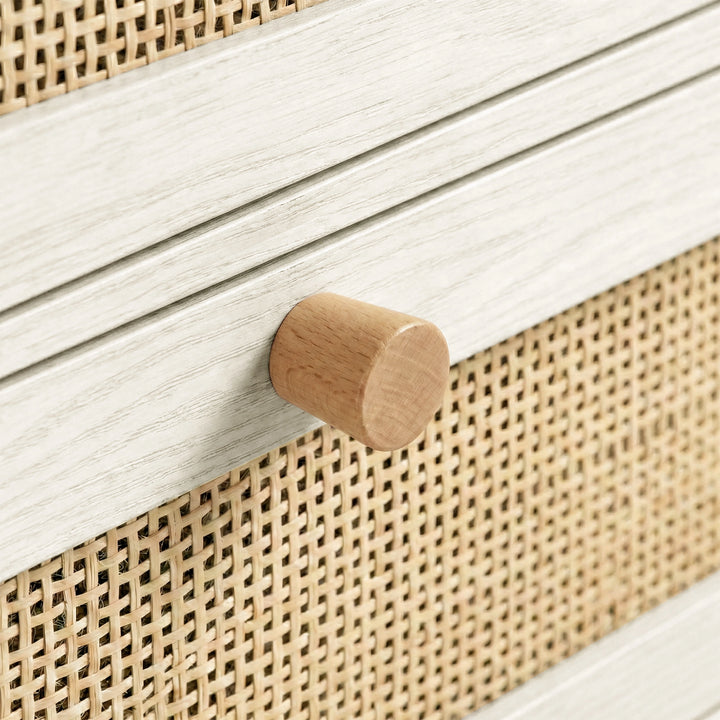 [White] Wovena chest close-up detail showing rounded solid wood knob against rattan weave drawer front panel