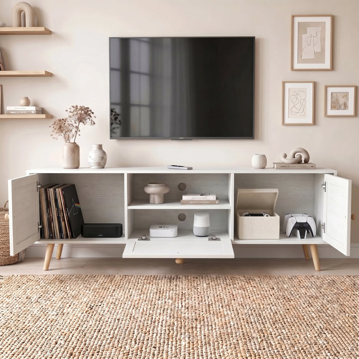 [White] Wovena Rattan TV Unit with doors and drawer open showing vinyl records, books, Apple TV, smart speaker, and game controllers inside