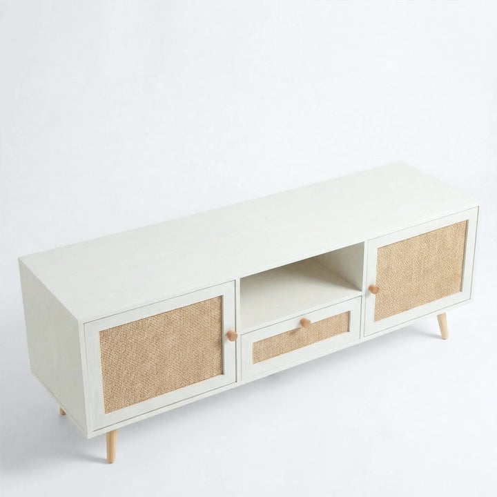 [White] Wovena Rattan TV Unit shown on plain white background featuring two cane doors, centre drawer, open shelf, and tapered wooden legs