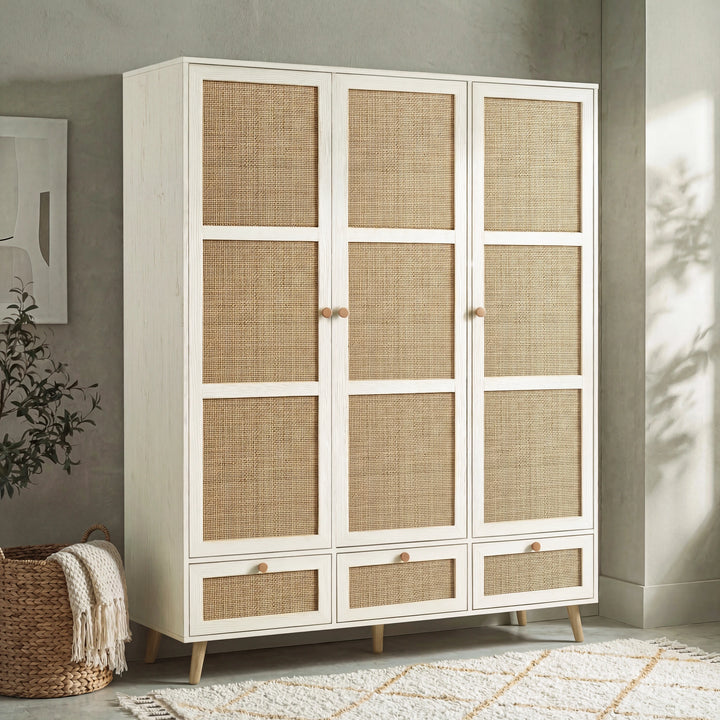 [White] Wovena rattan wardrobe three-quarter angle in a styled bedroom with natural light and wall shadows