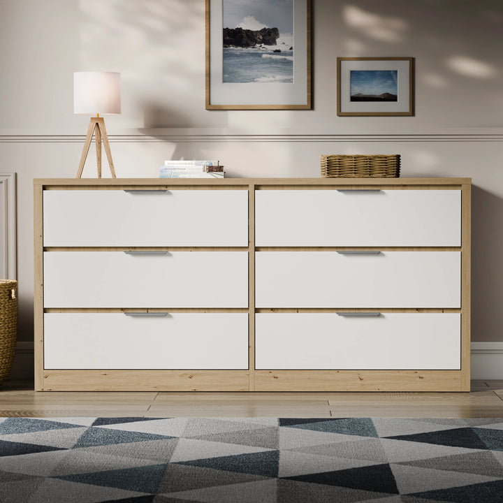 [Oak+White] Skova 6 drawer chest below framed seascape art with geometric rug in foreground