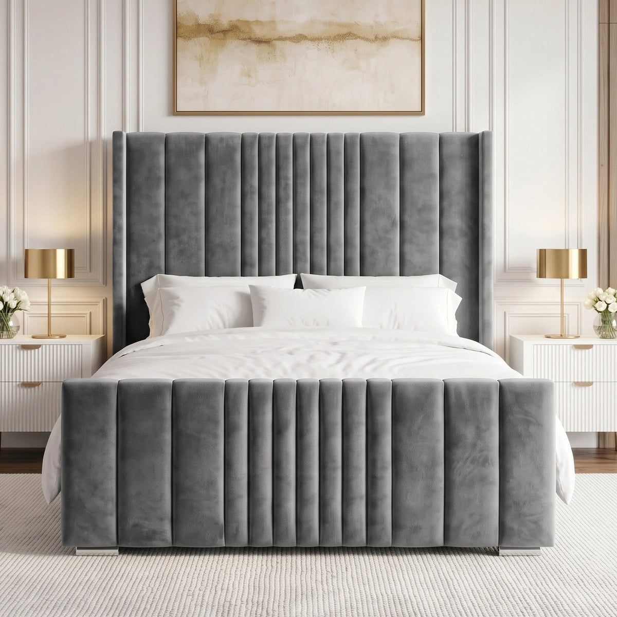 [King | Grey] velvet bed frame with a tall, channel-tufted headboard and matching footboard, styled in a contemporary bedroom with white bedding, white nightstands, gold lamps, and a neutral wall paneling.