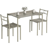 [Wooden Grey] Angled studio view of the three-piece dining set with two chairs, circular backs, mugs and a flower vase