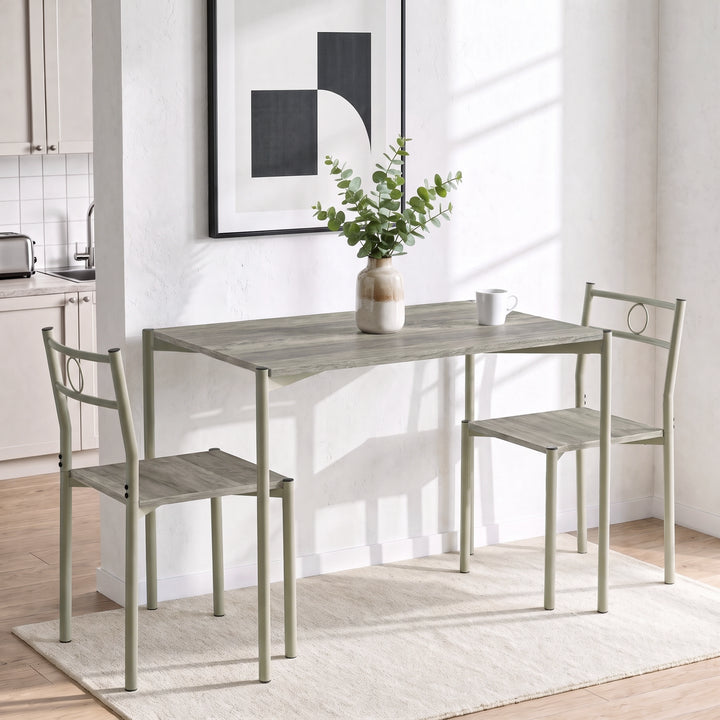 [Wooden Grey] Bright kitchen lifestyle view with the two-chair table set, a mug and a ceramic vase on the tabletop