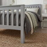 [Single | Grey] Foot-end of grey wooden single bed with slatted footboard, jute rug below and bedding draped