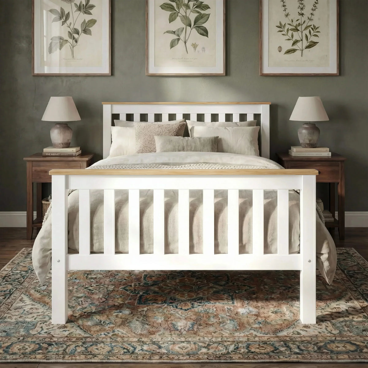 [Single | White + Pine] wooden bed frame with a slatted headboard and footboard, styled with beige bedding in a bedroom setting with two nightstands, lamps, framed botanical prints, and a patterned rug.