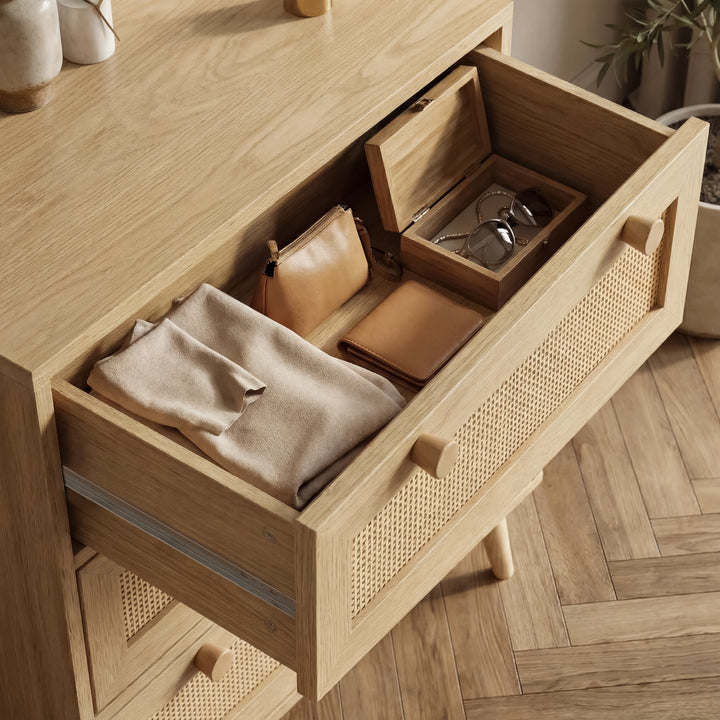 [Oak Effect] Open top drawer detail on Wovena rattan chest of drawers showing organised personal items inside