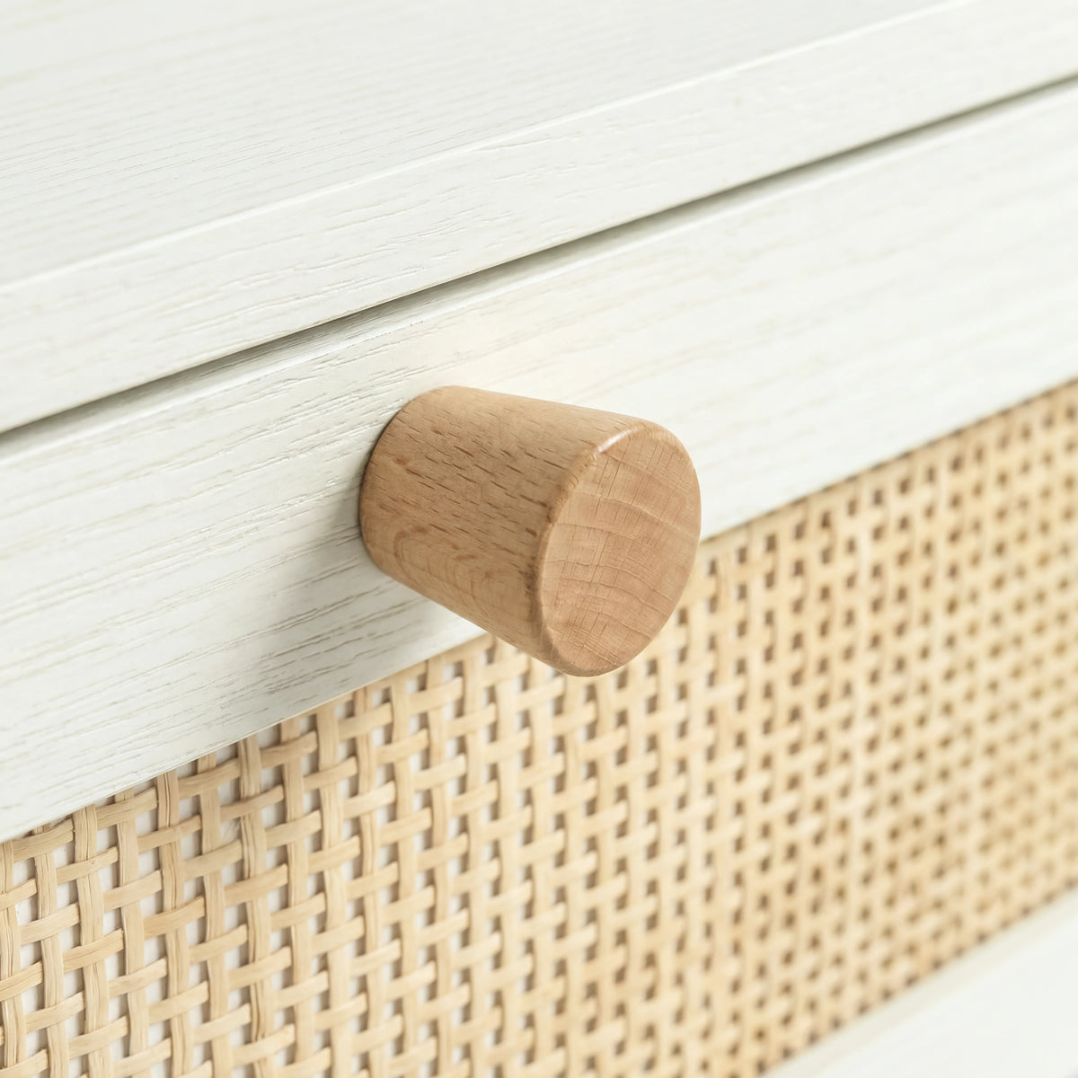 [White] Close-up of Wovena rattan bedside showing tight cane weave panel and round natural pine knob handle
