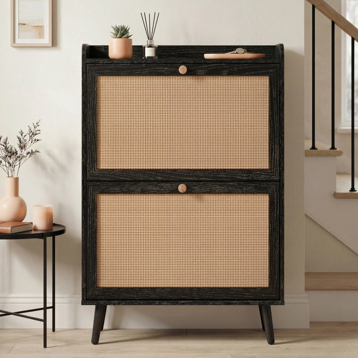 [Black] Wovena Rattan Black 2 Door Shoe Storage Cabinet front-facing in neutral hallway with black balustrade staircase and round black side table alongside